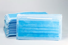 Stack of blue disposable 3-ply face masks